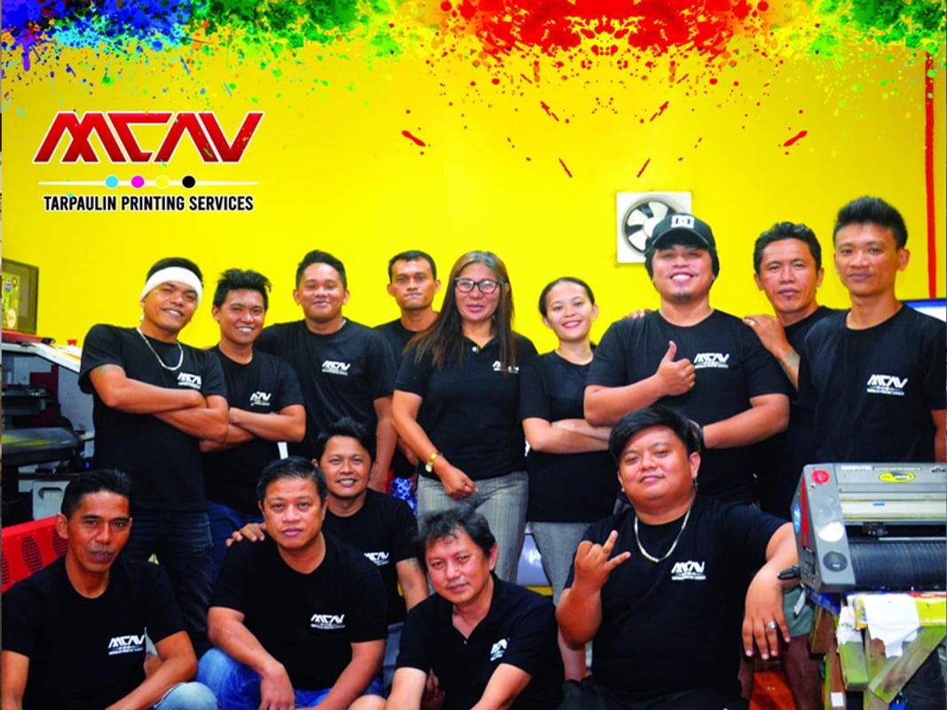 The MCAV crew in front of the shop's yellow wall