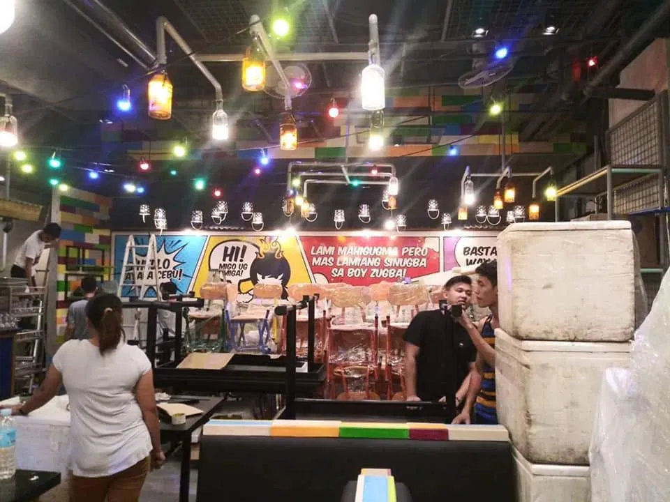 MCAV crew installing a Boy Zugba vinyl graphics at Ayala Center Cebu