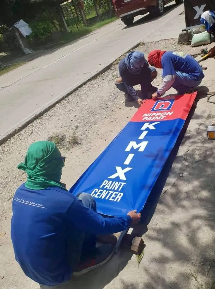 MCAV crew installing a Kimix Paint Center Panaflex sign
