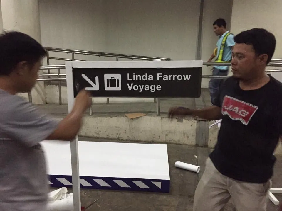 MCAV crew installing a Linda Farrow sign