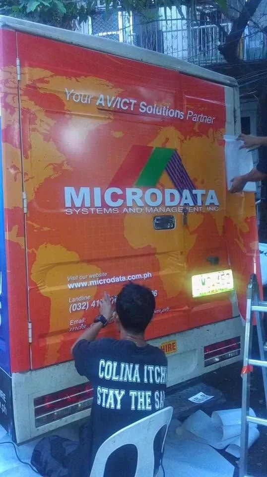 MCAV crew installing a Microdata Systems and Management, Inc. vehicle wrap