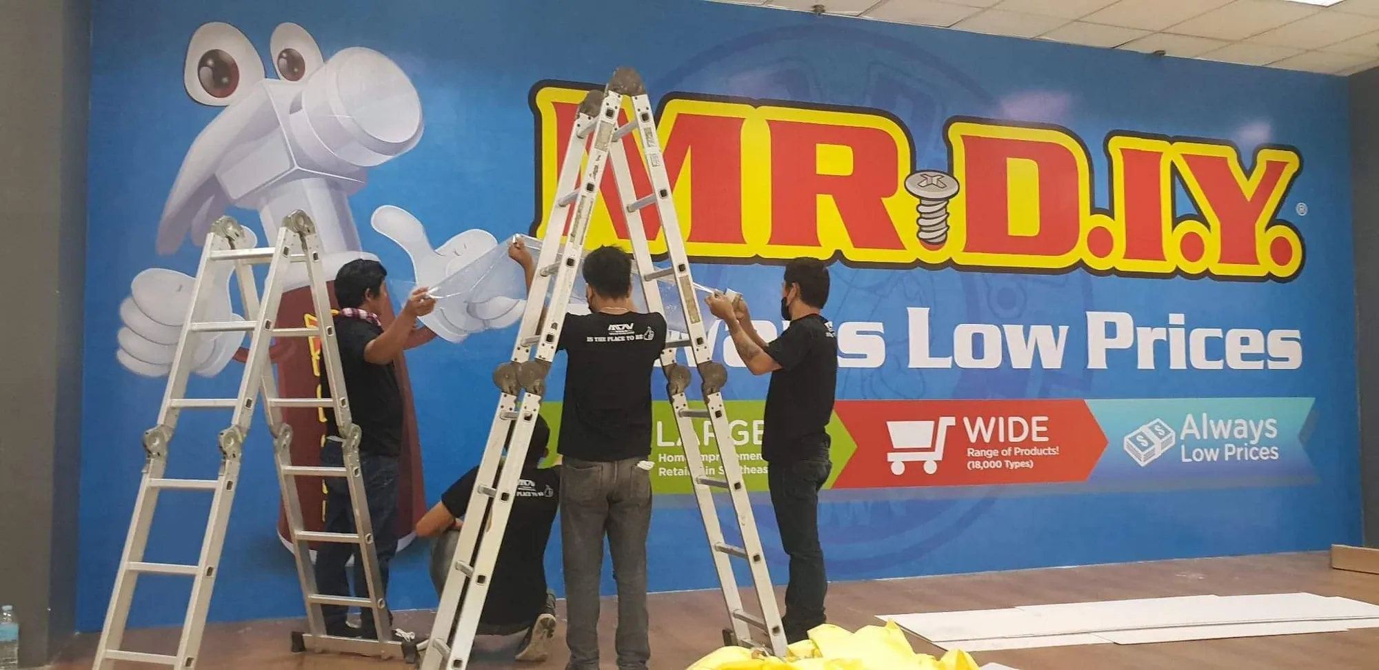 MCAV crew installing a Mr. D.I.Y. vinyl graphics