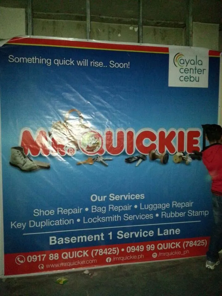 MCAV crew installing a Mr. Quickie tarpaulin at Ayala Center Cebu
