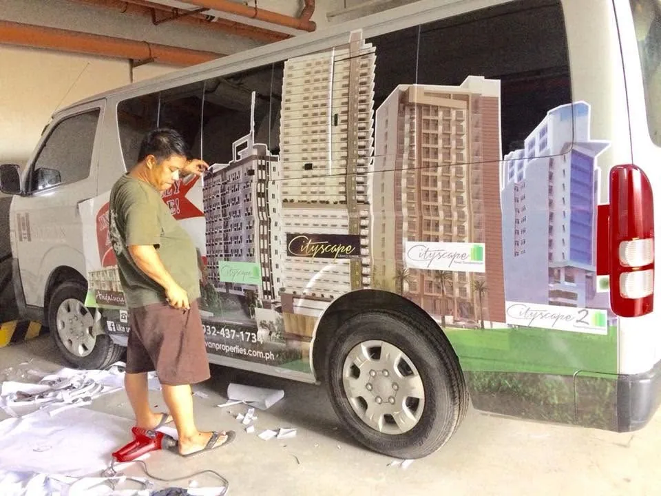 MCAV crew installing a MyVan Properties & Development Inc. vehicle wrap