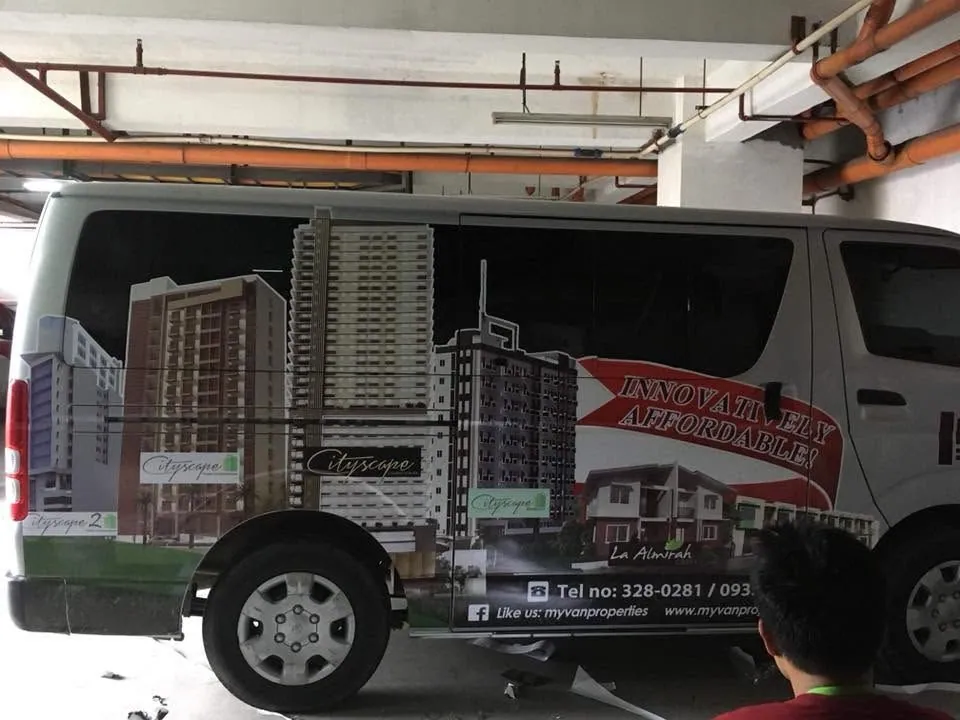 MCAV crew installing a MyVan Properties & Development Inc. vehicle wrap