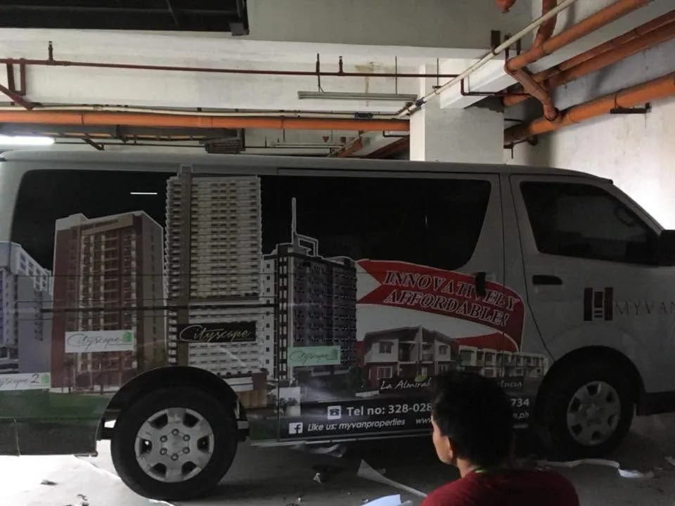 MCAV crew installing a MyVan Properties & Development Inc. vehicle wrap