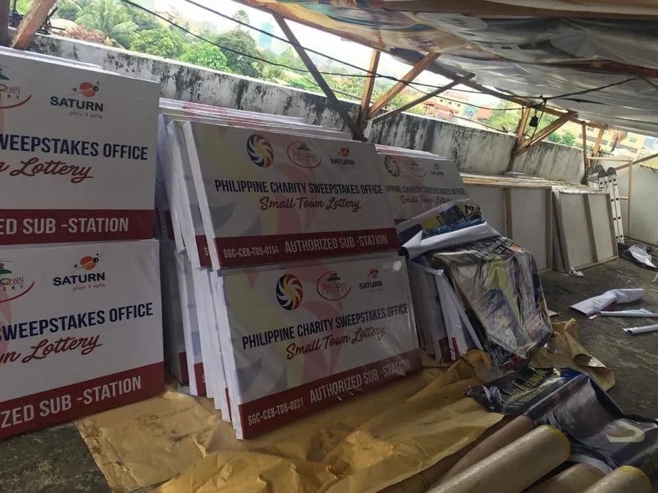 PCSO framed tarpaulin, fresh off MCAV's printer