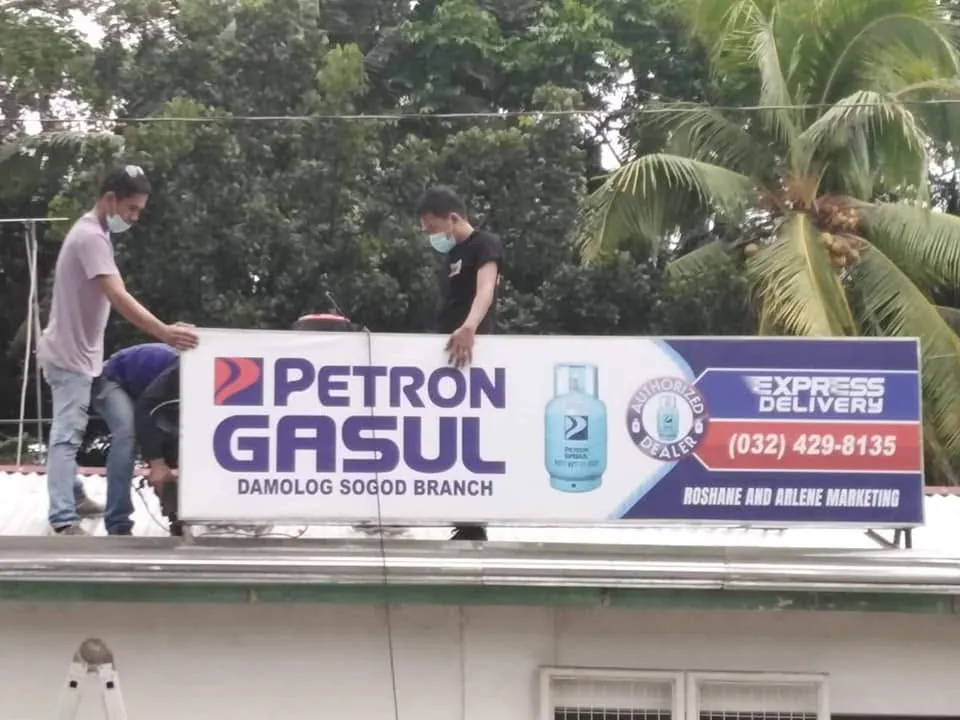 MCAV crew installing a Petron Panaflex sign at Damolog, Sogod, Cebu