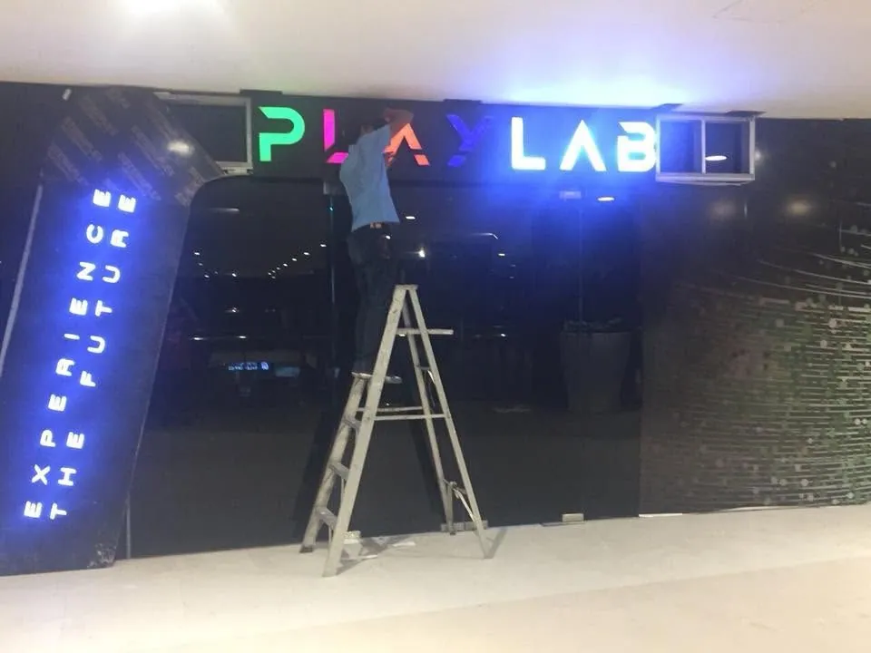 MCAV crew installing a PlayLab lighted sign