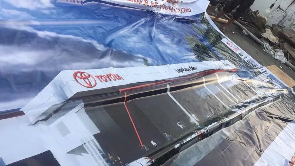 MCAV crew installing a Toyota tarpaulin